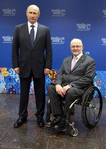 Russian President Vladimir Putin, left, and International Paralympic Committee President Philip Craven pose at a meeting with International Paralympic Committee board members and honorary council members before the opening ceremony of the 2014 Winter Paralympics in Sochi, Russia, Friday, March 7, 2014. AP