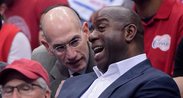 NBA Commissioner Adam Silver, left, talks with Magic Johnson as they watch the Los Angeles Clippers play the Oklahoma City Thunder in the first half of Game 4 of the Western Conference semifinal NBA basketball playoff series, Sunday, May 11, 2014, in Los Angeles. AP