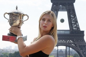 Russia's Maria Sharapova poses with the trophy in front of the Eiffel Tower, one day after defeating Romania's Simona Halep in the women's final of the French Open tennis tournament in Paris, France, Sunday, June 8, 2014. AP