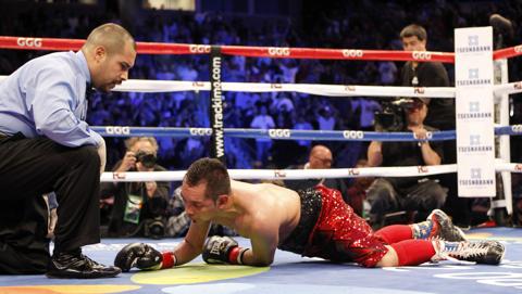 Referee Raul Caiz Jr., left, watches Nonito Donaire on the canvas after Donaire lost to Nicholas Walters in the sixth round during a WBA featherweight title boxing fight, Saturday, Oct. 18, 2014, in Carson, California. AP