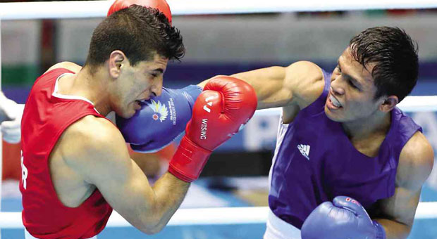 INQUIRER FILE PHOTO - THE PHILIPPINES’ Charly Suarez (in blue) connects against Jordan’s Mohammad Mustafa Alkasbeh during their men’s lightweight (60 kg) semifinal fight. NIÑO JESUS ORBETA 