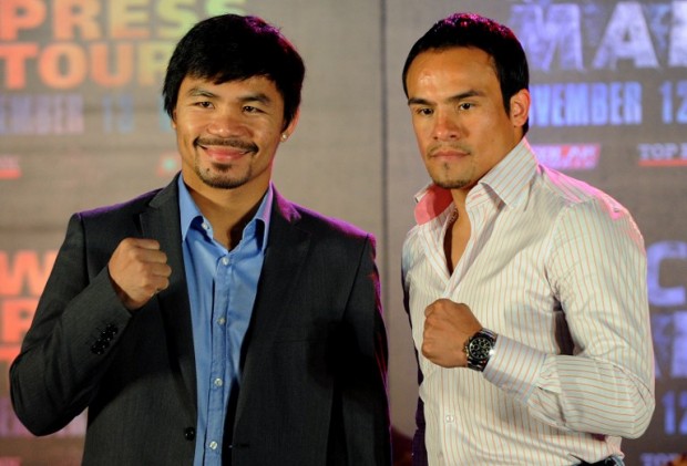Eight-time world boxing champion Manny Pacquiao (L) of the Philippines and Mexican Juan Manuel Marquez (R) pose for the media  for the start of a series of a four-city international media tour of their November 12 bout. AFP PHOTO / JAY DIRECTO