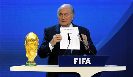 In this Dec. 2, 2010 file picture FIFA President Joseph S. Blatter announces that Qatar will be hosting the 2022 Soccer World Cup, during the FIFA 2018 and 2022 World Cup Bid Announcement in Zurich, Switzerland. A FIFA task force on Tuesday, Feb. 24, 2015 recommended playing the 2022 World Cup in November-December to avoid the summer heat in Qatar. The plan must be approved by the FIFA executive committee, chaired by Blatter, at a March 19-20, 2015 meeting in Zurich. (AP Photo/Keystone/Walter Bieri, File)