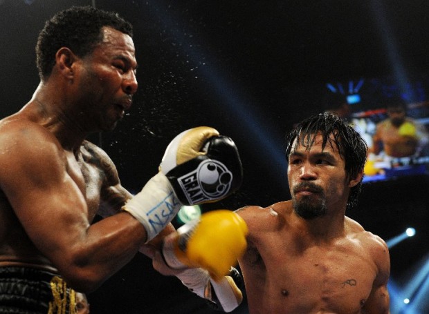 Manny Pacquiao of the Philippines (R) lands a punch against Shane Mosley of the US (L) during their bout for the World Boxing Organization (WBO) welterweight title at the Garden Arena in the MGM Grand in Las Vegas, Nevada on May 7, 2011. Pacquiao retained the WBO welterweight title by beating Mosley to extend his winning streak to 14 bouts.    AFP PHOTO / GABRIEL BOUYS