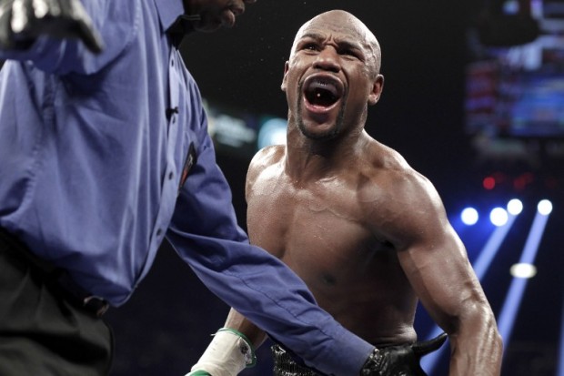 Floyd Mayweather Jr. of the US reacts accusing Marcos Maidana of Argentina on September 13, 2014 at The MGM Grand, Las Vegas. Mayweather dominated with a 12 round unanimous decision over Maidana retaining his WBA Welterweight Belt and WBC Welterweight and Super Welterweight World Titles.    (Photo John Gurzinski / AFP)