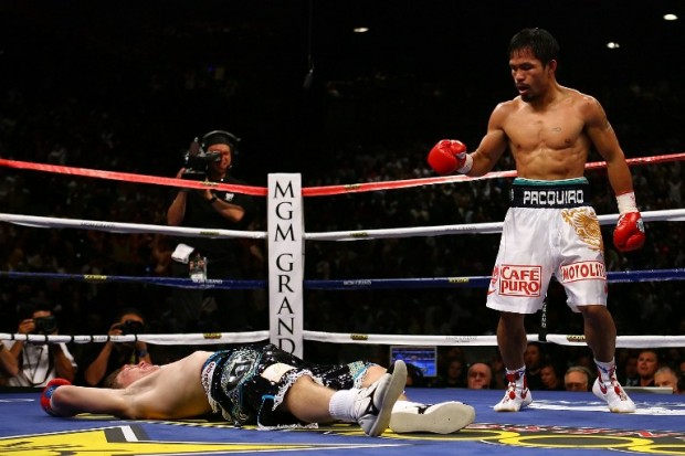 Manny Pacquiao of the Philippines stands over Ricky Hatton of England after Pacquiao knocked him out in the second round during their junior welterweight title fight at the MGM Grand Garden Arena May 2, 2009 in Las Vegas, Nevada.   Al Bello/Getty Images/AFP