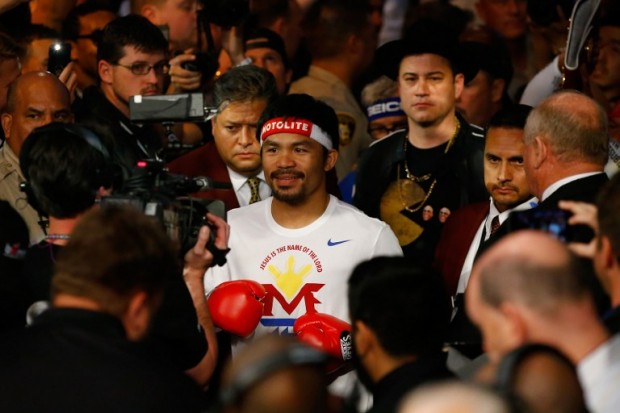 Manny Pacquiao walks to the ring with Jimmy Kimmel before his welterweight unification championship bout against Floyd Mayweather Jr. on May 2, 2015 at MGM Grand Garden Arena in Las Vegas, Nevada.   Al Bello/Getty Images/AFP