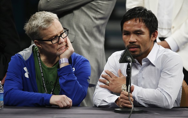 FILE - In this May 2, 2015 photo, trainer Freddie Roach, left, listens as Manny Pacquiao answers questions during a press conference following his welterweight title fight against Floyd Mayweather Jr. in Las Vegas. Pacquiao could face disciplinary action from Nevada boxing officials for failing to disclose a shoulder injury before the fight. Nevada Athletic Commission Chairman Francisco Aguilar said that the state attorney generals office will look at why Pacquiao checked no a day before the fight on a commission questionnaire asking if he had a shoulder injury. (AP Photo/John Locher)