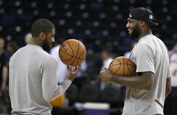 Cleveland Cavaliers' Kyrie Irving, left, and LeBron James talk during NBA basketball practice, Wednesday, June 3, 2015, in Oakland, Calif. The Golden State Warriors host the Cavaliers in Game 1 of the NBA Finals on Thursday. (AP Photo/Ben Margot)