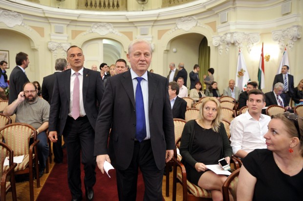 President of the Hungarian Olympic Committee Zsolt Borkai, left and Budapest Mayor Istvan Tarlos, centre, arrive for the general meeting of the Metropolitan Municipality in Budapest, Hungary, Tuesday, June 23, 2015. The general meeting voted Budapest as the candidate city to host the Summer Olympics in 2024. (Attila Kovacs/MTI via AP)