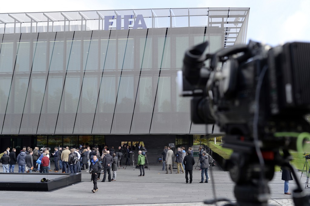 Media representatives wait outside of the FIFA headquarters in Zurich, Switzerland as board members arrive at the FIFA headquarters in Zurich, Switzerland, Tuesday Oct.  20, 2015. A FIFA Executive Committee meeting will take place at the Home of FIFA in Zurich. (Walter Bieri/Keystone via AP)