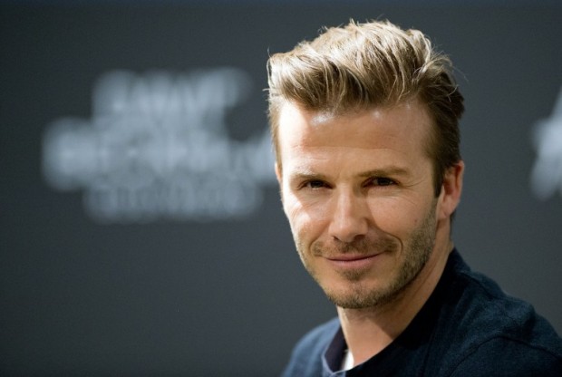 (FILES) -- A file photo taken on March 19, 2013 shows British footballer David Beckham attending a commercial assignment at H&M store in Berlin. Beckham was declared "sexiest man alive" by People magazine on November 17, 2015, joining an elite club including last year's winner, Chris Hemsworth, and a handful of other above-average men.    AFP PHOTO / JOHANNES EISELE