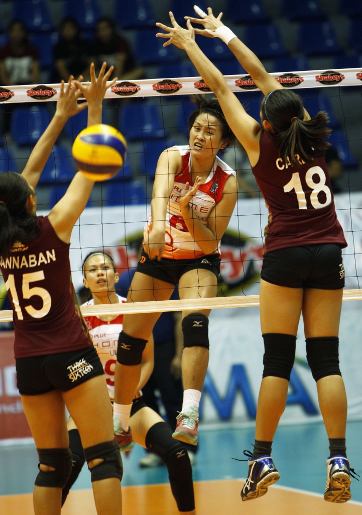 PLDT’s Gretchel Soltones (center) defies UP’s Diana Carlos (18) and Aiesha Gannaban’s defense to punch in a kill during their Shakey’s V-League Season 12 Reinforced Conference clash at The Arena in San Juan yesterday.