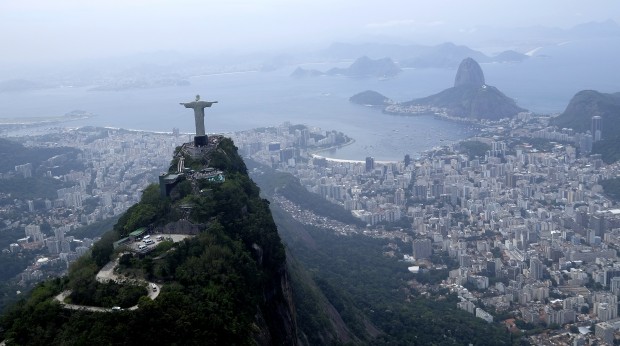 FILE - In this Oct. 9, 2015, file photo, the Christ the Redeemer statue is shown in this aerial view of Rio de Janeiro,Braizl. Organizing committee spokesman Mario Andrada said on Tuesday, Jan, 19, 2016, that they are disappointed with ticket sales with Olympics opening in just over six months. (AP Photo/David J. Phillip, File)