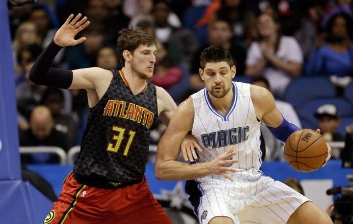 Orlando Magic center Nikola Vucevic, right, looks for a way to the basket around Atlanta Hawks forward Mike Muscala (31) during the second half of an NBA basketball game, Sunday, Feb. 7, 2016, in Orlando, Fla. AP