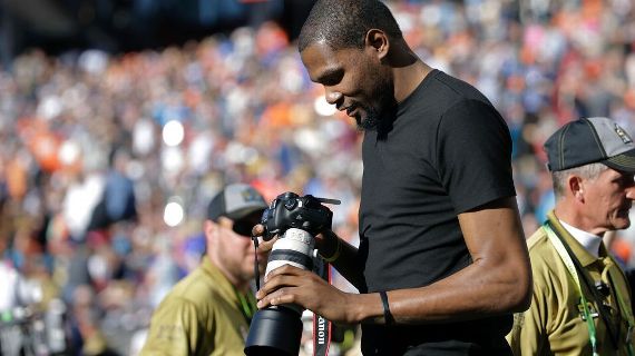 Oklahoma City Thunder star Kevin Durant takes pictures as credentialed photographer at Super Bowl 50. AP