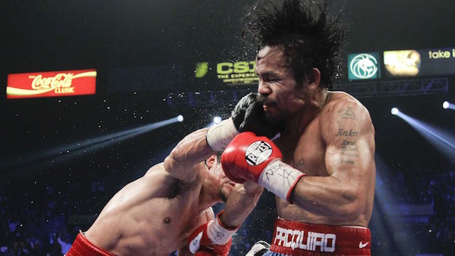 Manny Pacquiao gets hit with a solid right by Juan Manuel Marquez. AP