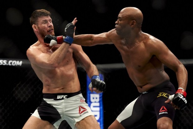 British fighter Michael Bisping (L) competes with Anderson Silva of Brazil (R) during their middleweight bout at the Ultimate Fighting Championship (UFC) Fight Night event in London on February 27, 2016. Bisping beat Silva on a judge's decision over five rounds. / AFP / NIKLAS HALLE'N