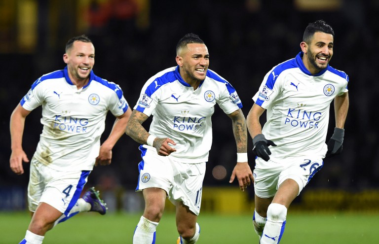 Leicester Ciy's Riyad Mahrez (R) celebrates after scoring his team's first goal with  English midfielder Danny Drinkwater (L) and Danny Simpson (C) during their Barclays Premier League football match between Watford and Leicester Ciy' at Vicarge Road, North London, England on 5 March, 2016.  AFP File photo