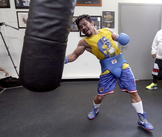 In this Monday, April 4, 2016, photo, boxer Manny Pacquiao, of the Philippines works out in front of reporters and photographers at the Wild Card gym in Los Angeles. Pacquiao is scheduled to fight Timothy Bradley in Las Vegas on Saturday, April 9. (AP Photo/Nick Ut)