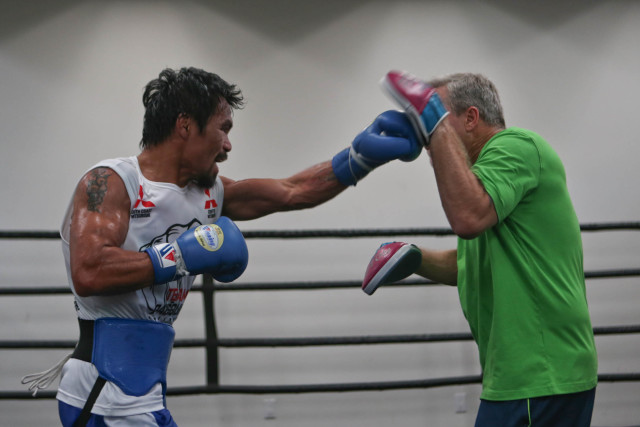 Manny Pacquiao works the mitts with trainer Freddie Roach inside the Wild Card Gym in Los Angeles, California on Saturday afternoon. Pacquiao and Bradley will be fighting for the third time on April 9 at the MGM Grand Garden Arena in Las Vegas. PHOTO BY REM ZAMORA