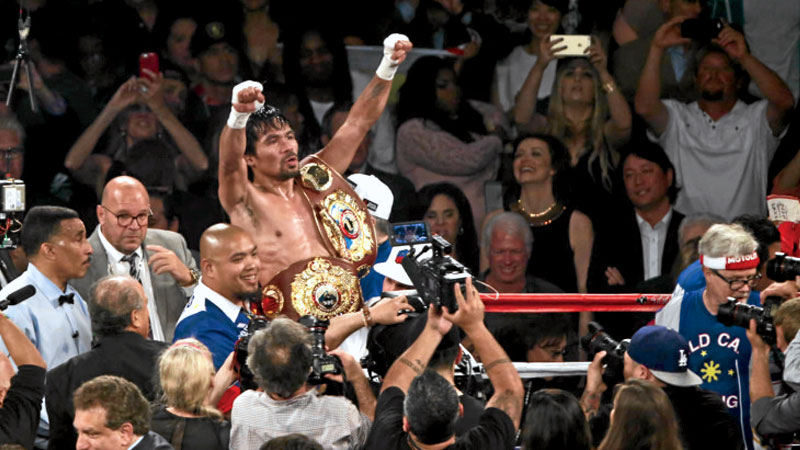 BOWING OUT IN STYLE Manny Pacquiao celebrates after beating Timothy Bradley via unanimous decision at MGM Grand Garden Arena in Las Vegas on Saturday night. REM ZAMORA FOR CAFE PURO