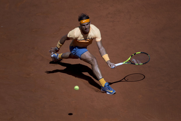 Rafael Nadal, from Spain, lunges to return a ball against Andrey Kuznetsov, from Russia, during a Madrid Open tennis tournament match in Madrid, Spain, Tuesday, May 3, 2016. Nadal won 6-3, 6-3. (AP Photo/Francisco Seco)