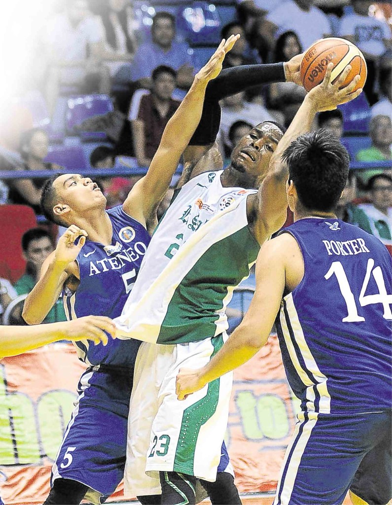 LA SALLE slotman Ben Mbala pivots for a shot off Vince Tolentino and Kris Porter of Ateneo in yesterday’s Final Four encounter at Filoil Flying V Centre in San Juan. AUGUST DELA CRUZ