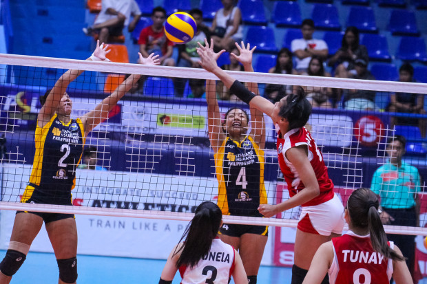 Jeanette Panaga of Cignal over Standard's Pau Soriano and Florence May Madulid. 