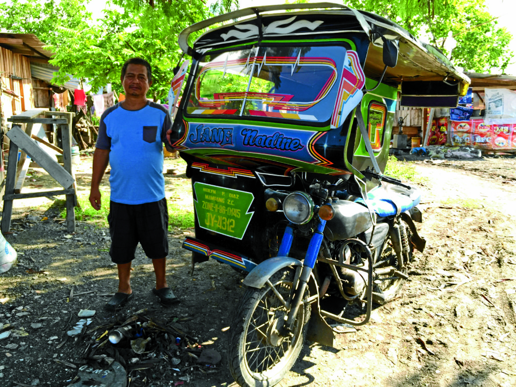 Mr. Eduardo Diaz, father of Hidilyn, showed the tricycle her daughter brought through her income from being a weightlifter. PHOTO BY JULIE ALIPALA/INQUIRER MINDANAO