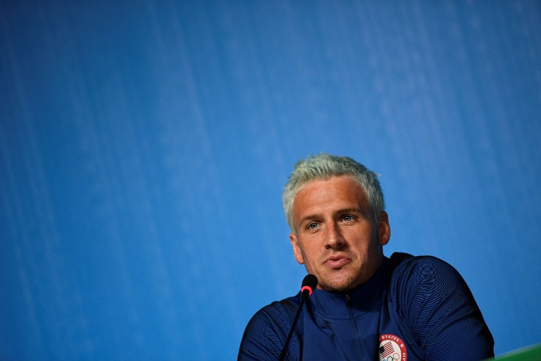 (FILES) This file photo taken on August 03, 2016 shows US swimmer Ryan Lochte holding a press conference in Rio de Janeiro, two days ahead of the opening ceremony of the Rio 2016 Olympic Games. Star American swimmer Ryan Lochte said August 20, 2016 he took "full responsibility" for vandalizing a gas station bathroom and then telling police an "overexaggerated" story about it during the Rio Olympics. The episode, which has embarrassed the US sporting superpower, saw Lochte and three other gold-winning US swimmers embroiled in a controversy after he gave a shocking -- and false -- account of how they had been robbed at gunpoint.  / AFP PHOTO / MARTIN BUREAU