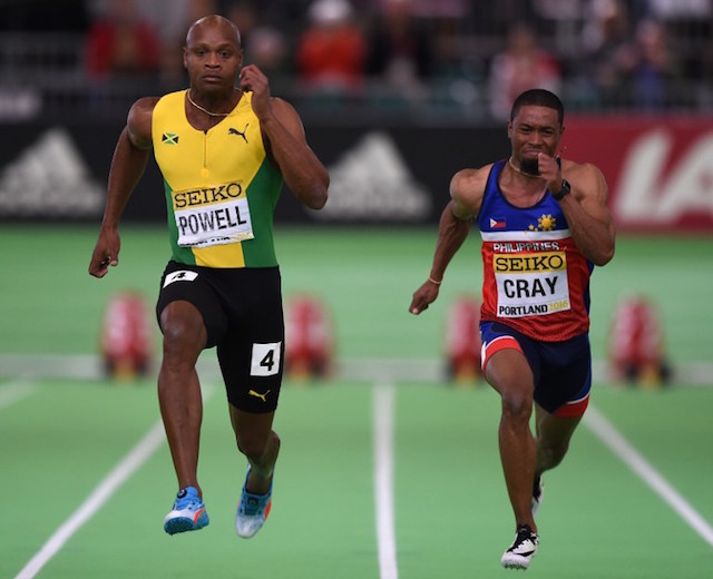 The Philippines Eric Cray, right, and Jamaica's Asafa Powell compete during the 60 meters semi-final at the IAAF World Indoor athletic championships in Portland, Oregon on March 18, 2016. AFP / DON EMMERT