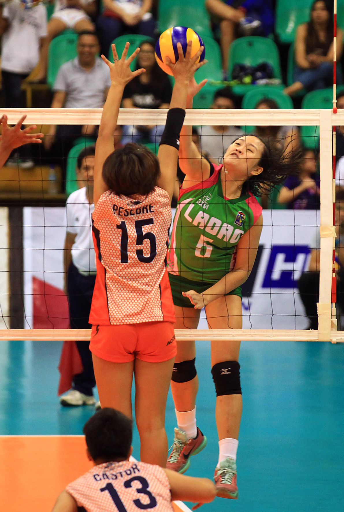 Team Laoag’s ace hitter Grethcel Soltones (5) challenges Coast Guard’s Alarnie Pesebre’s defense during their Shakey’s V-League Reinforced Conference encounter at the Philsports Arena. CONTRIBUTED PHOTO  