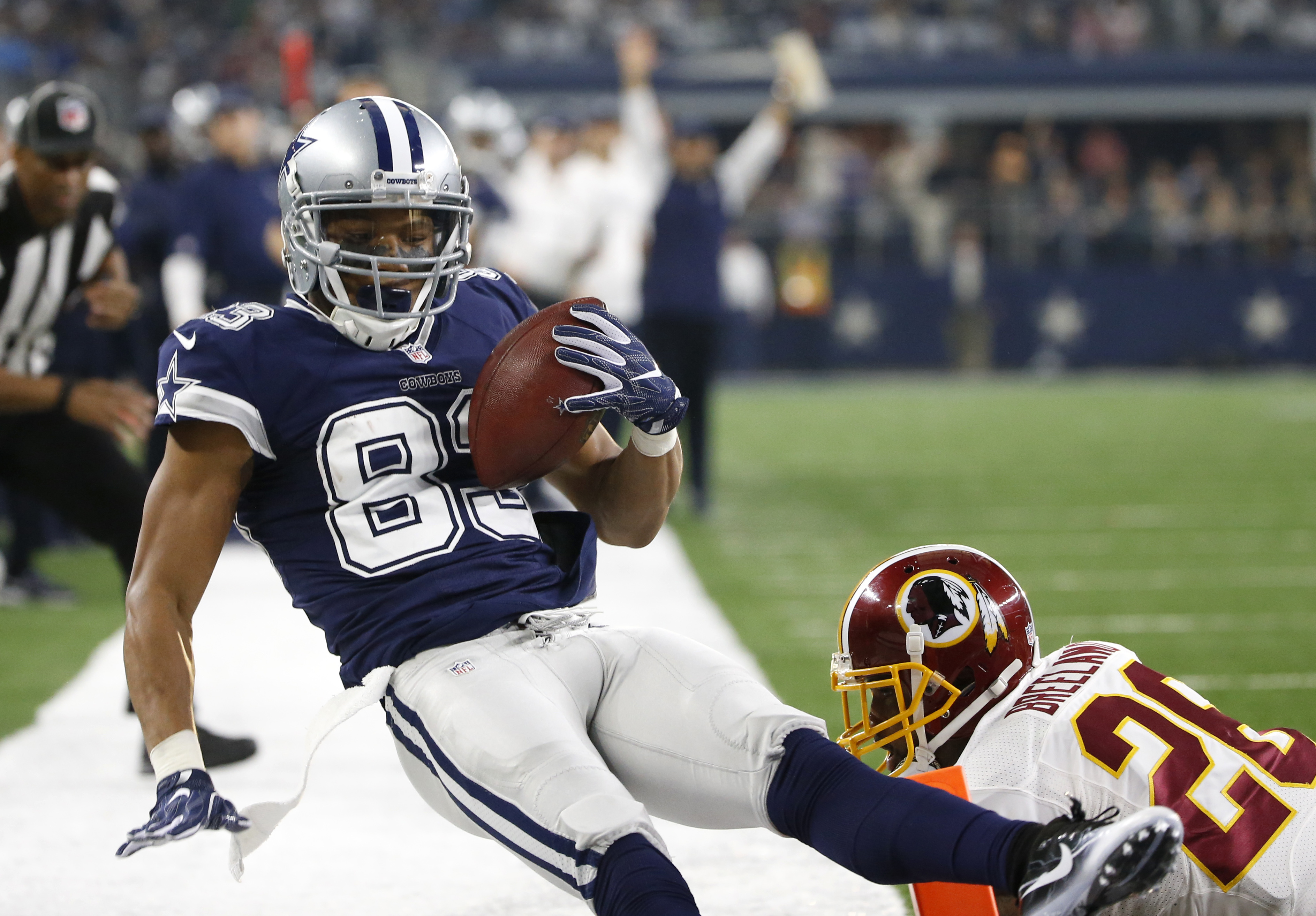 Dallas Cowboys wide receiver Terrance Williams (83) is pushed out of the end zone by Washington Redskins' Bashaud Breeland (26) after Williams caught a pass for a touchdown during the first half of an NFL football game, Thursday, Nov. 24, 2016, in Arlington, Texas. (AP Photo/Ron Jenkins)