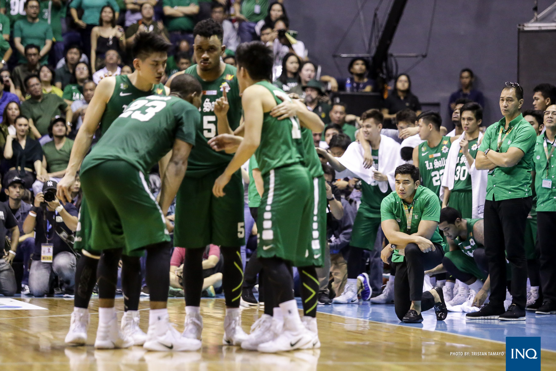 Ben Mbala (23), Jeron Teng and the rest of the Archers on the court plan an offensive play as coach Aldin Ayo (kneeling at right) looks on. “We all have the roles and a game plan to play as a team,” says Mbala. Photo by Tristan Tamayo/INQUIRER.net