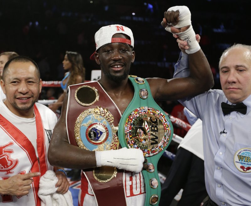 Terence 'Bud' Crawford is declared winner over John Molina Jr. after a WBO junior welterweight boxing bout at the CenturyLink Center in Omaha, Neb., Saturday, Dec. 10, 2016. Crawford won by TKO in the eighth round. AP