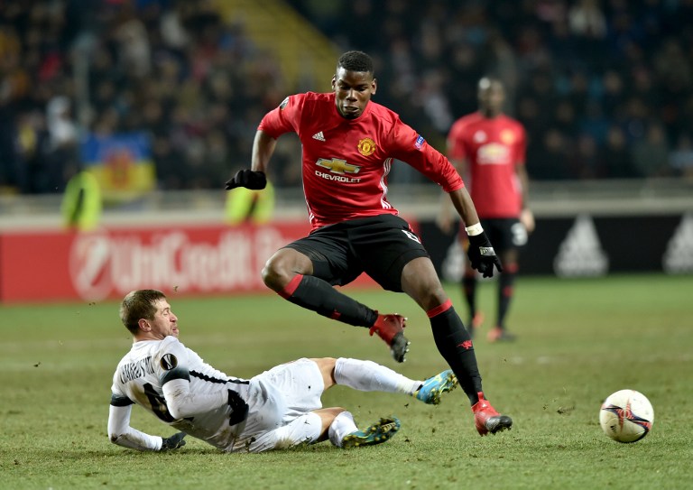 FC Zorya Luhansk  Ihor Chaykovskiy   (down) and  (Paul Pogba of Manchester United FC  vie for a ball during their UEFA Europa League football match FC Zorya Luhansk  and Manchester United FC at the Chornomorets  stadium in Odessa on December 8, 2016. AFP PHOTO/ Sergei SUPINSKY / AFP PHOTO / Sergei SUPINSKY