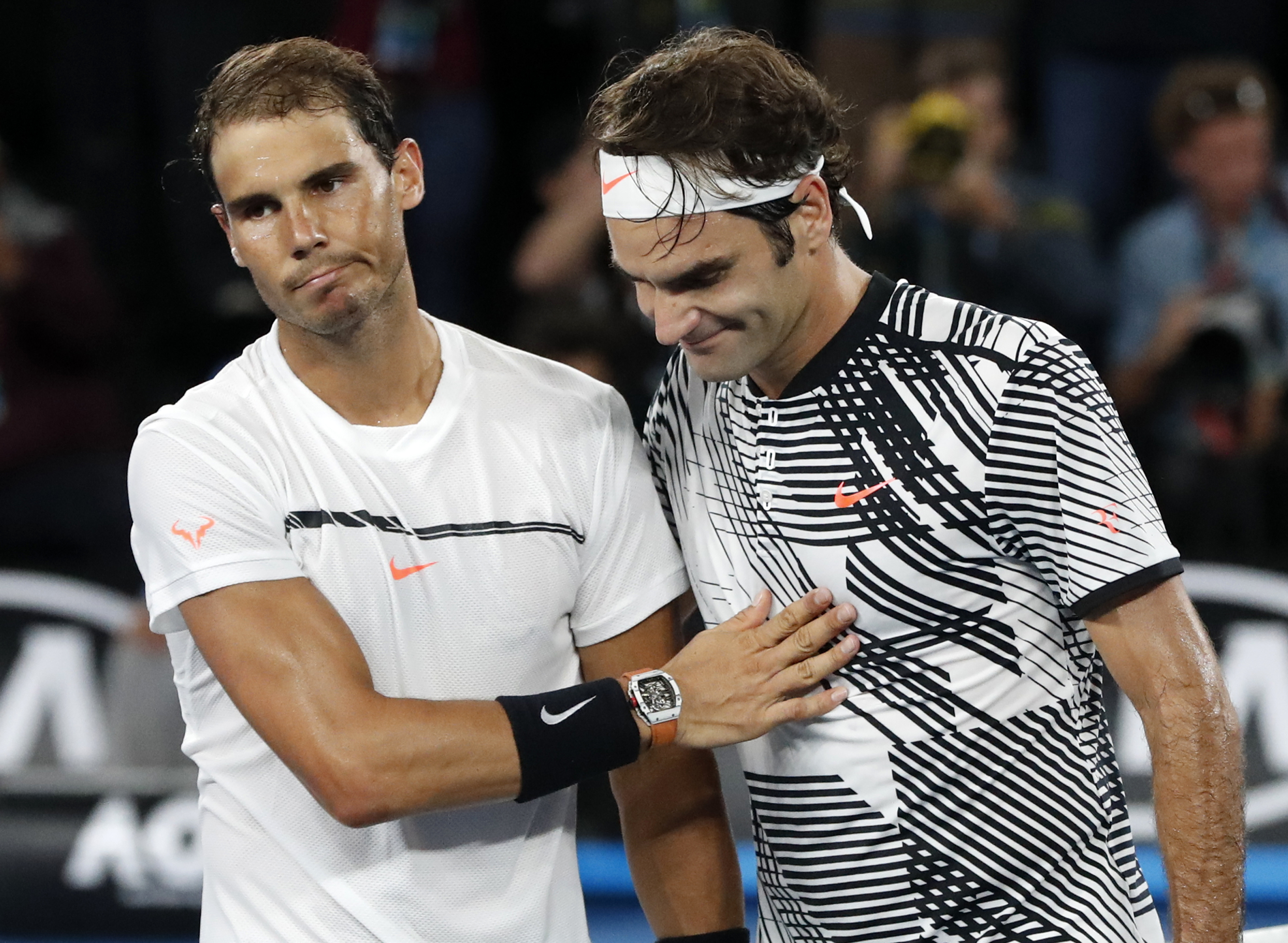 Switzerland's Roger Federer, right, is congratulated by Spain's Rafael Nadal, after Federer won the men's singles final at the Australian Open tennis championships in Melbourne, Australia, Sunday, Jan. 29, 2017.(AP Photo/Dita Alangkara)