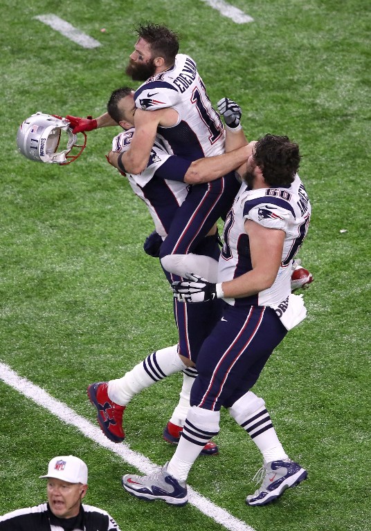 HOUSTON, TX - FEBRUARY 05: Tom Brady #12, Julian Edelman #11 and David Andrews #60 of the New England Patriots celebrate after defeating the Atlanta Falcons during Super Bowl 51 at NRG Stadium on February 5, 2017 in Houston, Texas. The Patriots defeated the Falcons 34-28.   Ezra Shaw/Getty Images/AFP