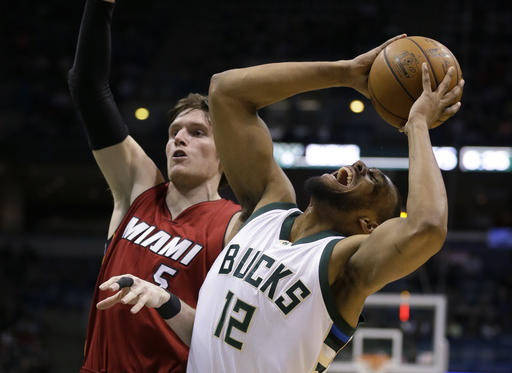 Milwaukee Bucks' Jabari Parker (12) grimaces as he drives against the Miami Heat's Luke Babbitt during the second half of an NBA basketball game Wednesday, Feb. 8, 2017, in Milwaukee. Parker was injured on the play and left the game. AP PHOTO