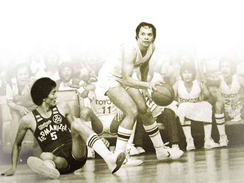 Toyota stalwart Robert Jaworski bears down on a fallen Crispa center Abet Guidaben during an All-Filipino title series in the 1970s.