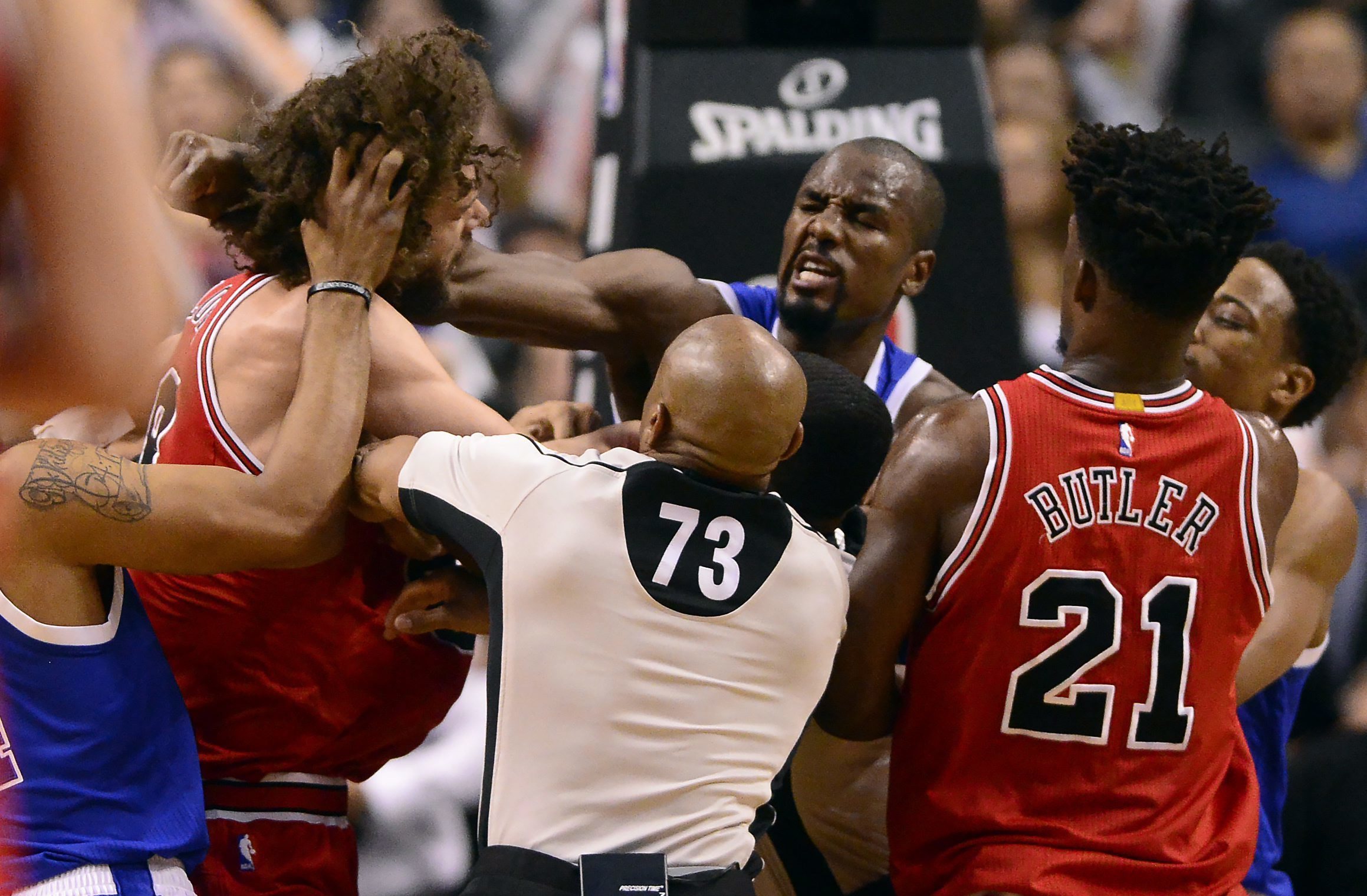 Toronto Raptors forward Serge Ibaka (9) lands a strike on Chicago Bulls center Robin Lopez (8) during a scuffle  during second half of an NBA basketball game in Toronto, Tuesday, March 21, 2017. (Frank Gunn/The Canadian Press via AP)