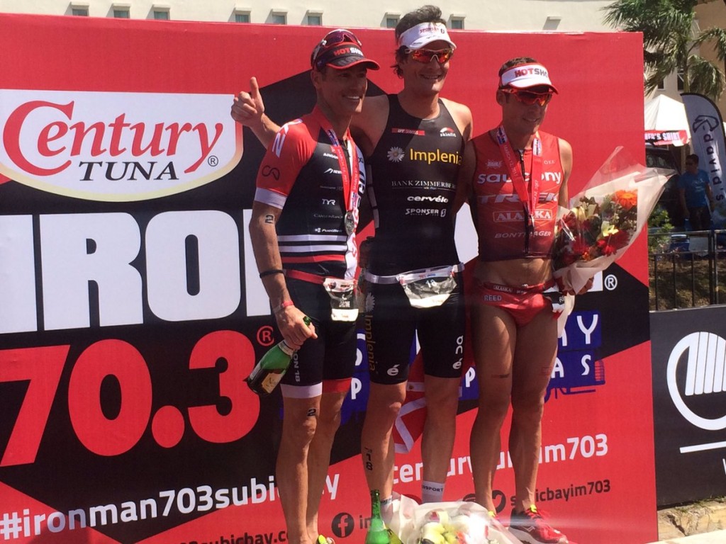 Ruedi Wild (center) poses with second placer Craig Alexander (left) and Tim Reed (right) after the 2017 Century Tuna Ironman 70.3 Subic Bay triathlon race. Photo by Randolph B. Leongson