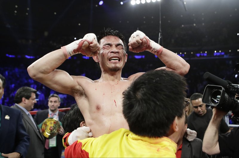 Srisaket Sor Rungvisai, of Thailand, celebrates after a super flyweight championship boxing match against Roman Gonzalez, of Nicaragua, Saturday, March 18, 2017, in New York. Rungvisai won the fight. (AP Photo/Frank Franklin II)