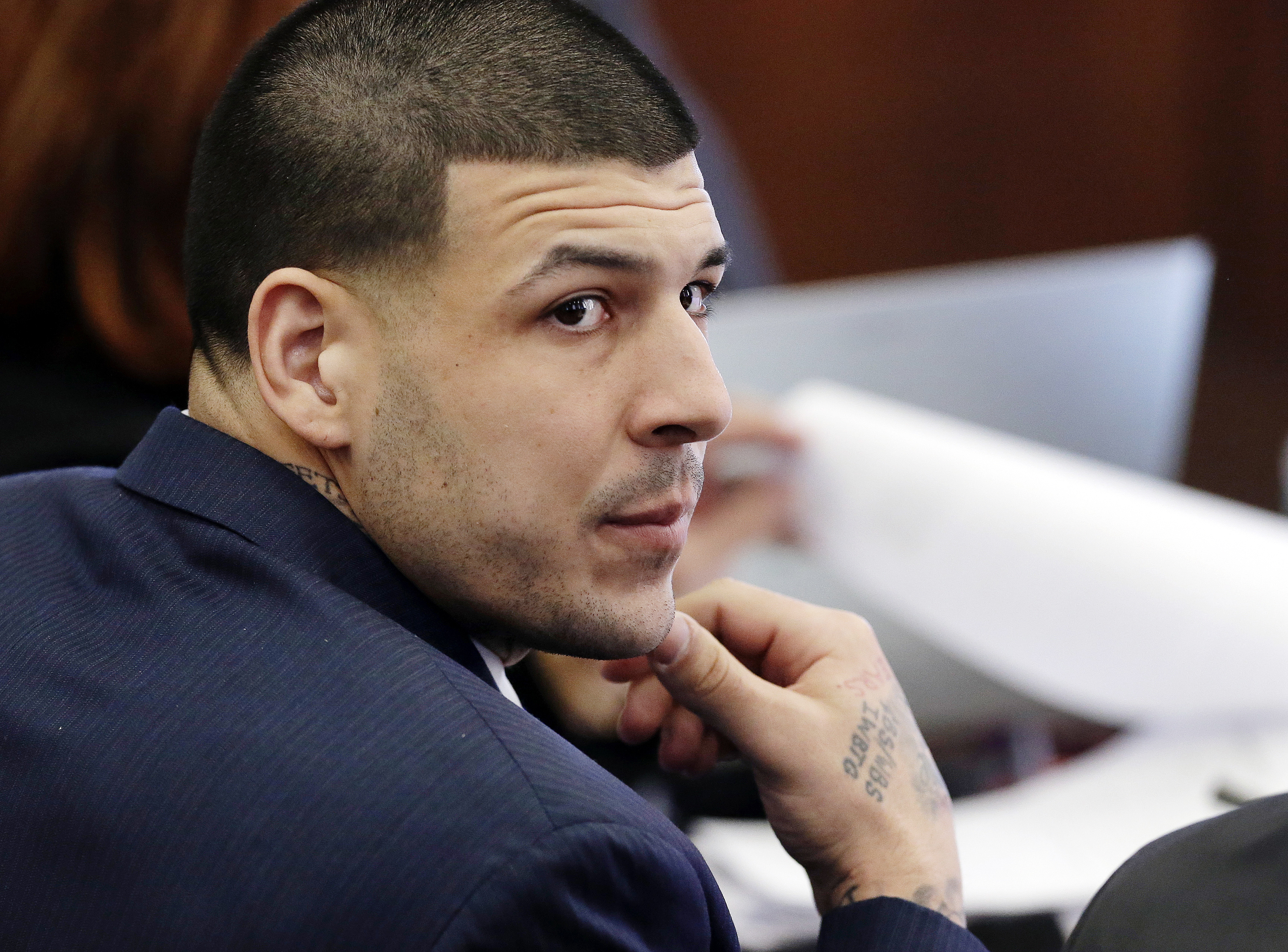 FILE - In this Wednesday, March 15, 2017, file photo, Defendant Aaron Hernandez listens during his double murder trial in Suffolk Superior Court, in Boston. Massachusetts prison officials said Hernandez hanged himself in his cell and pronounced dead at a hospital early Wednesday, April 19, 2017. (AP Photo/Elise Amendola, Pool, File)