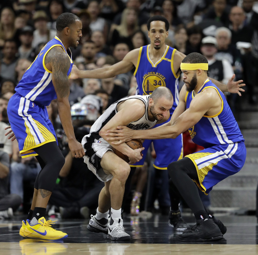 Golden State Warriors' Andre Iguodala, left, Shaun Livingston, rear, and JaVale McGee, right, challenge San Antonio Spurs' Manu Ginobili, center of Argentina for control of the ball during the first half in Game 4 of the NBA basketball Western Conference finals, Monday, May 22, 2017, in San Antonio.