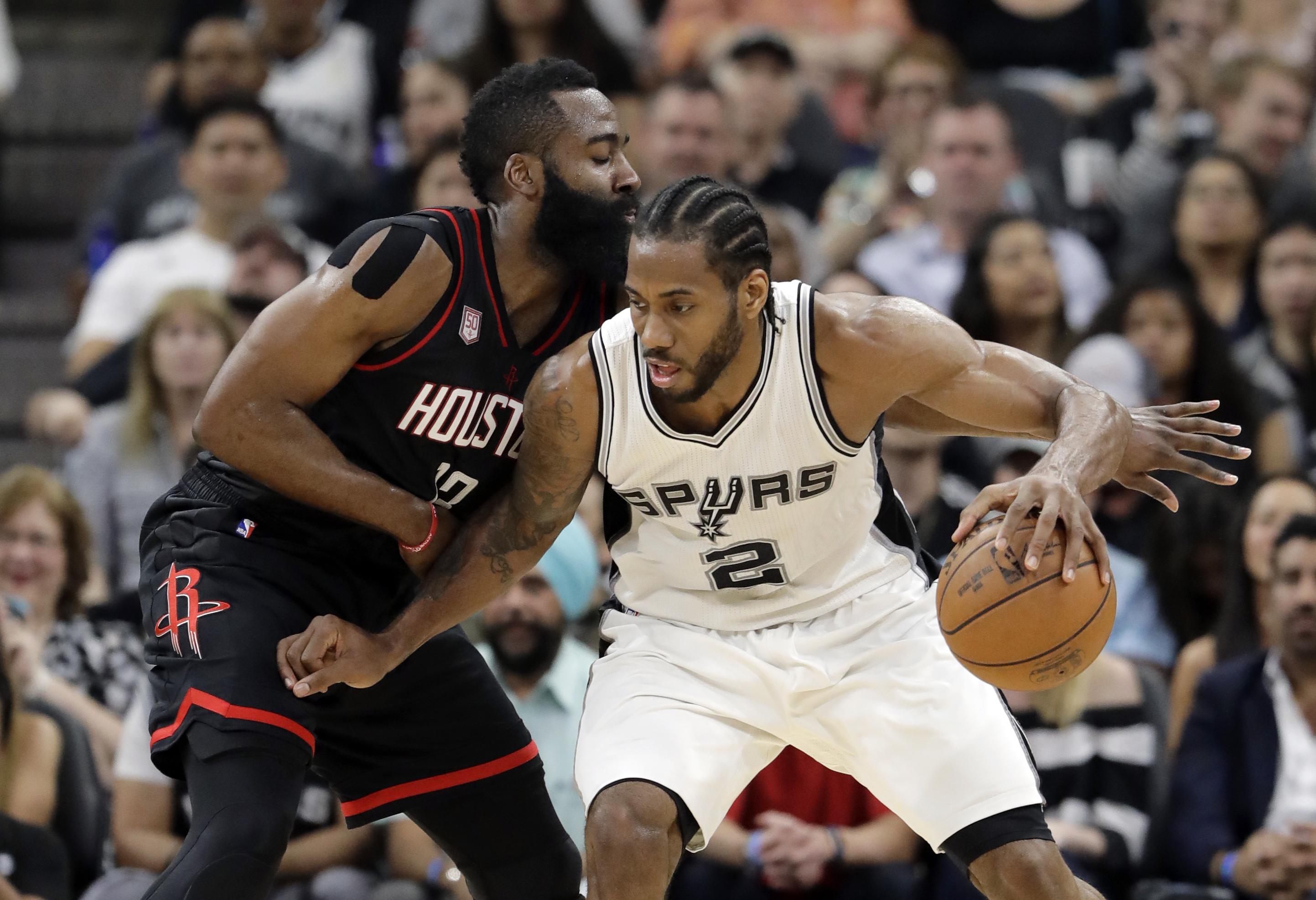 San Antonio Spurs forward Kawhi Leonard (2) works for an opportunity to the basket as Houston Rockets' James Harden, left, defends during the first half of Game 2 in a second-round NBA basketball playoff series, Wednesday, May 3, 2017, in San Antonio. (AP Photo/Eric Gay)