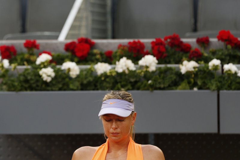 Maria Sharapova from Russia sits in a break during her Madrid Open tennis tournament match against Eugenie Bouchard from Canada in Madrid, Spain, Monday, May 8, 2017. Bouchard won 7-5, 2-6 and 6-4. (AP Photo/Francisco Seco)