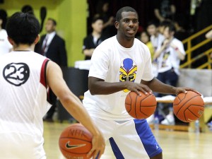 US basketball player Chris Paul from the New Orleans Hornets demonstrates his skill for young local players during a basketball clinic in Hong Kong, Tuesday, July 26, 2011. AP