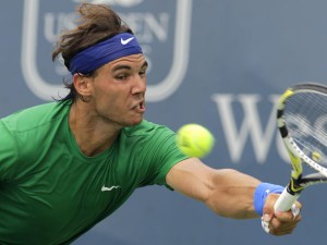TO TEE OFF OR NOT. Rafael Nadal, from Spain, hits a forehand against Mardy Fish in a quarterfinal match at the Western & Southern Open tennis tournament, Friday, Aug. 19, 2011 in Mason, Ohio. Fish won 6-3, 6-4.  AP Photo/Al Behrman